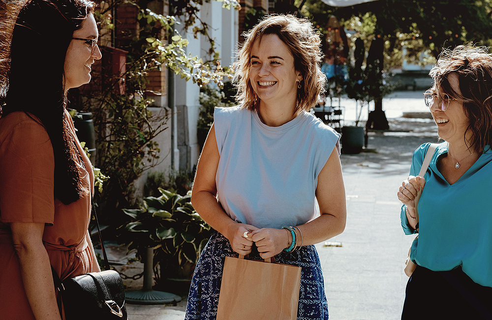 3 jonge dames zijn gezellig in gesprek op straat