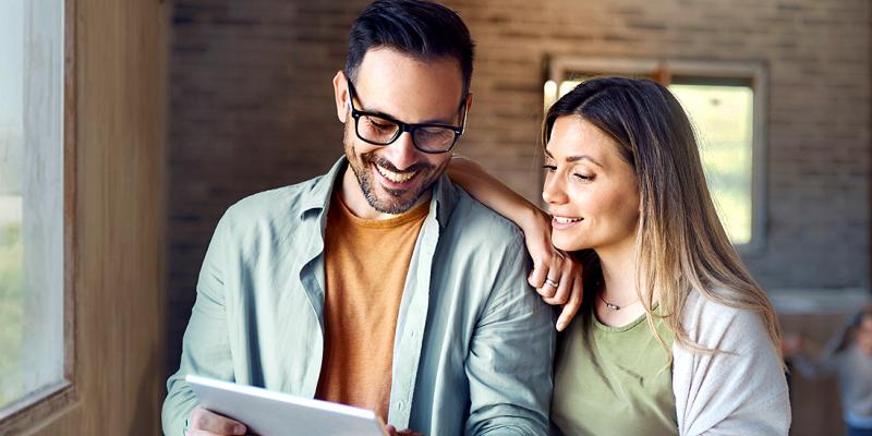 Un jeune couple consulte ses options d'assurance sur une tablette