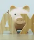 Spaarvarken achter grote TAX-letters