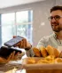 Un jeune homme satisfait paie sans contact à la boulangerie