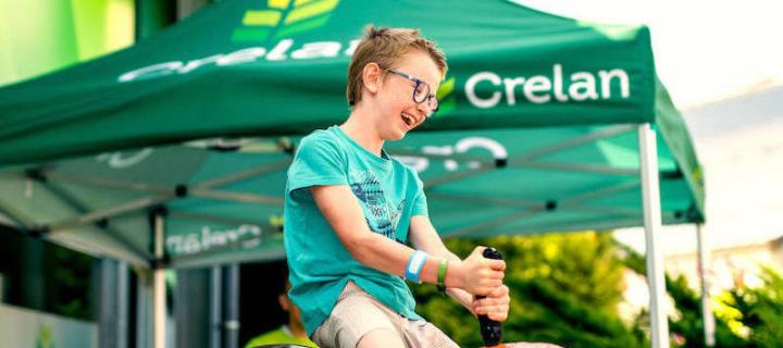 Picture of a boy on toy mechanical bull on a Crelan event